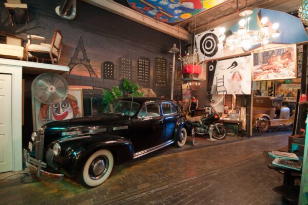Classic vehicle next to 1940's/ 1950's pop culture memorabilia at ARTISANworks in Rochester, NY